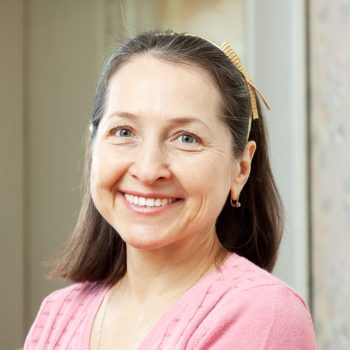 Portrait of smiling mature woman in home interior