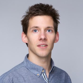 Close up portrait of a guy posing against gray background