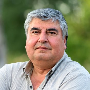 Smiling mature hispanic man posing looking at the camera